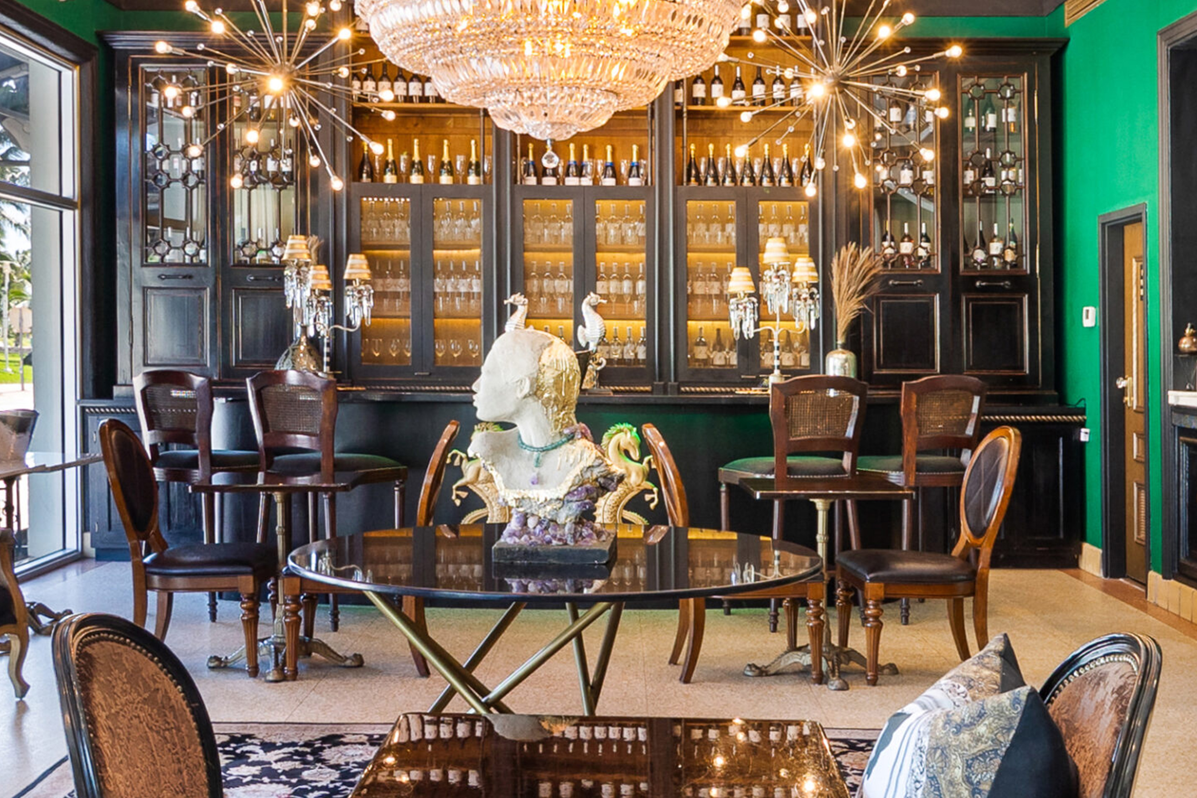 A luxurious lounge with a bar, seating area, and decorative items.